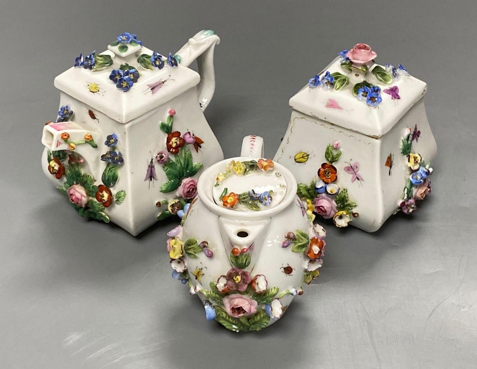 A late 19th century French porcelain flower encrusted cafe au lait set, on stand, stand 27cm